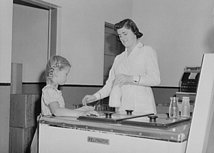 Child buying bottle of milk in Duluth