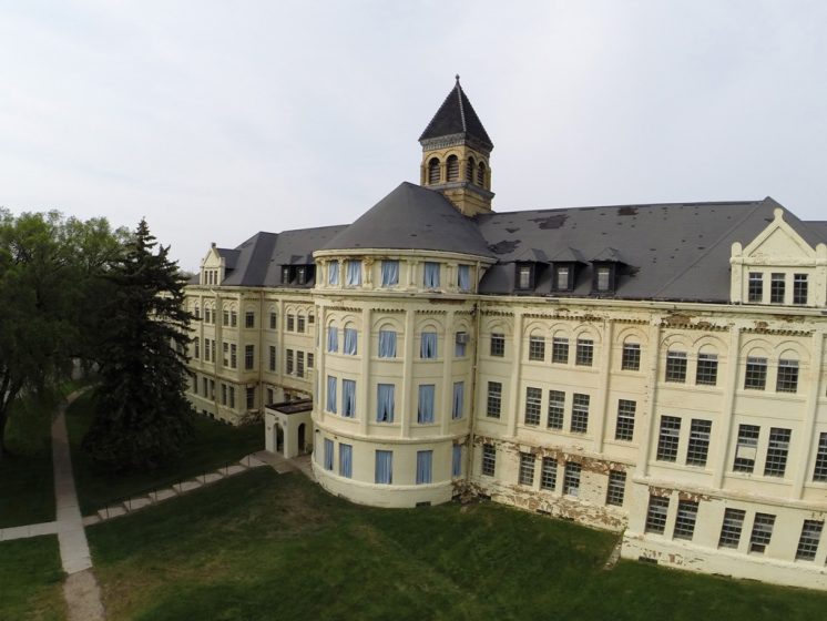 If you can’t see you can’t see, can’t you see?, 2015. Site-specific fabric installation. Sky blue fabric curtains were crafted and hung in the 32 windows of the far west rotunda of the Thomas Kirkbride designed Fergus Falls Regional Treatment Center aka the Third Minnesota State Hospital for the Insane. This installation considers the experience of looking and control from the dual perspectives of an exterior versus interior viewpoint.
