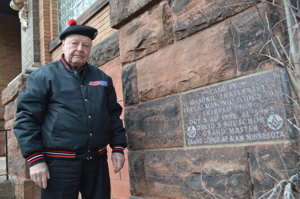 Retired 6th District Court Judge David Bouschor stands with the Euclid Lodge cornerstone. As Euclid Lodge 198 Grandmaster, Bouschor led a 1988 campaign to install a building cornerstone. (Photo by Mark Nicklawske)