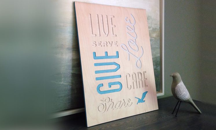 Custom carved wooden poster for Pelican Coffee.